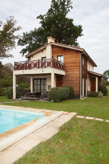 Fototapeta na wymiar Swimming pool and a wooden house