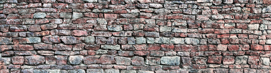 Stone wall panorama, panoramic stonewall pattern background, old aged weathered red grey grunge limestone dolomite slate slab rock texture, natural grungy, beige, yellow, gray brick vintage closeup