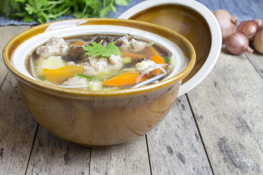 Thai soup recipe in a bowl on wooden