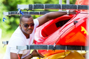 African man unloading boat from trailer © Kzenon