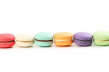 French colorful macarons on white background