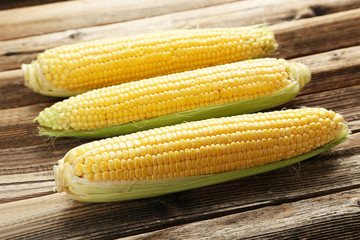 Corns on a brown wooden background