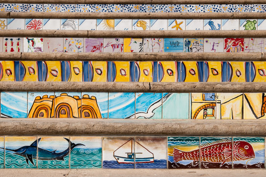 Close up view of some steps decorated with painted ceramic tiles of sea scenes along the seafront of Mazara del Vallo, West Sicily