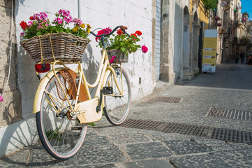 Tourist bike with flowered wicker basket along the streets of Ortigia, the old Syracuse