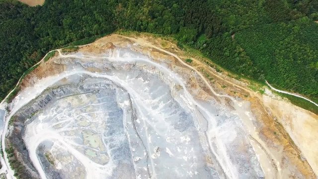 Aerial view of abandoned mine. Flight over industrial landscape after mining. 