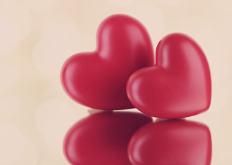 Red hearts on light background