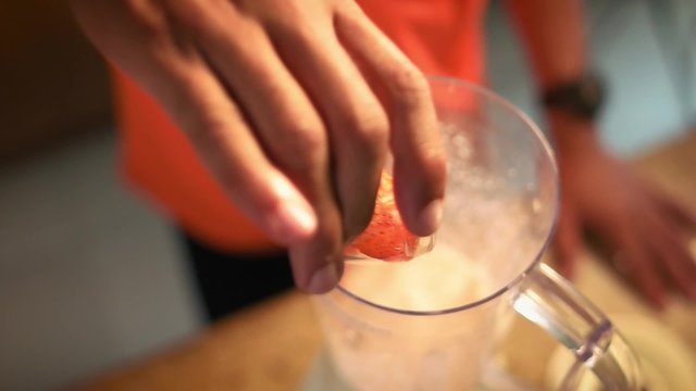 3 Man Prepares Protein Milk Shake With Strawberries