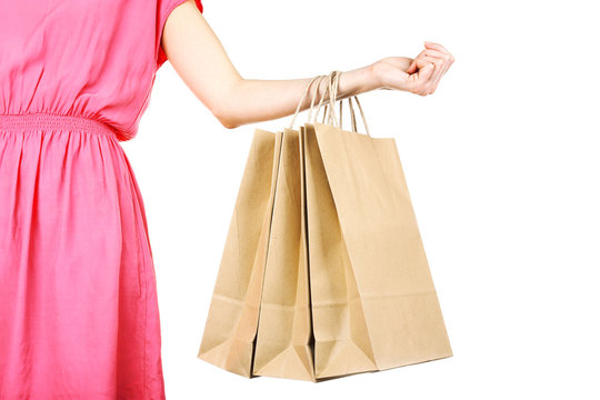 Woman holding paper shopping bag isolated on white