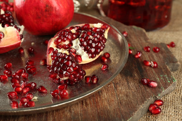 Pomegranate seeds on metal tray, closeup