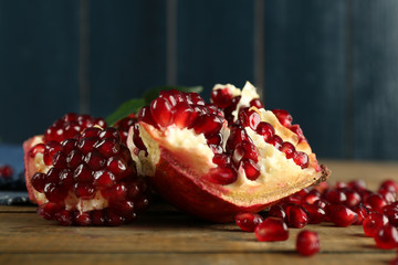 Pomegranate seeds on wooden table, closeup