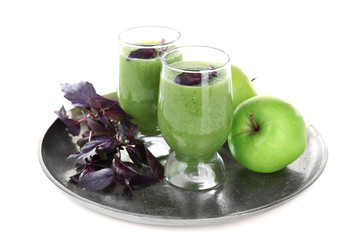 Glasses of green healthy juice with basil and apple isolated on white