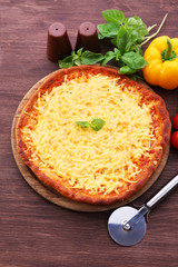 Cheese pizza with vegetables on table close up