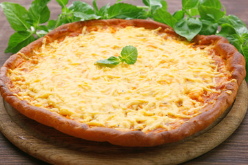 Cheese pizza with basil on table close up