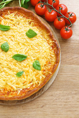 Cheese pizza with cherry tomatoes on table close up