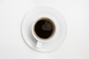 White coffee cup with coffee  on white background. View top