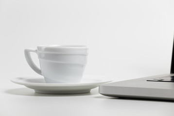 coffee cup and laptop on a white background