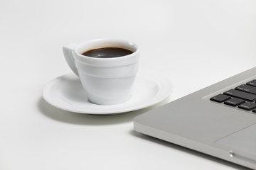 coffee cup and laptop on a white background