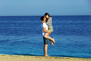 Fototapeta na wymiar Beautiful young couple on beach