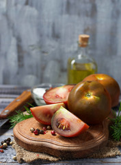 Black tomato kumato in wooden board