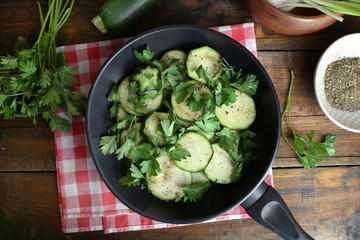Sliced zucchini in pan on table, top view