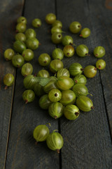 Green gooseberry on wooden background
