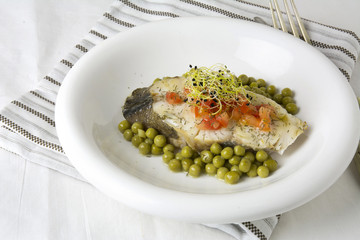Hake fillet with tomato and sprouts,