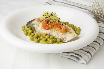 Hake fillet with tomato and sprouts,