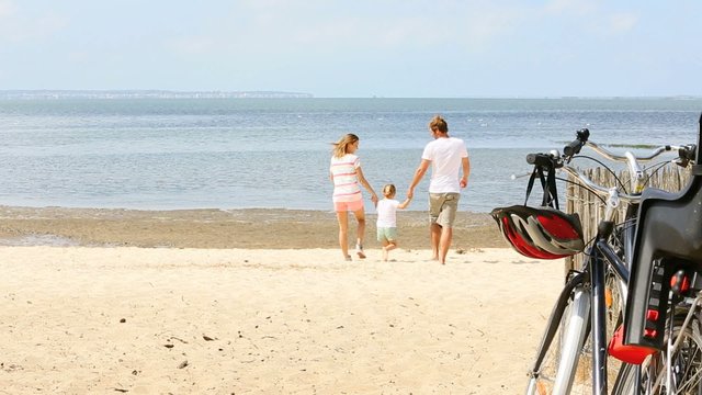 happy family running on a sandy beach