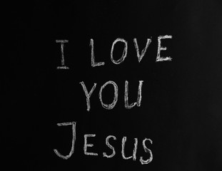 I LOVE YOU JESUS illustrated with chalk on black paper background