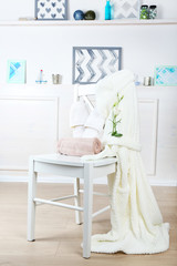Bath set with white bathrobe on chair, indoors