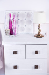 Table lamp on commode in room