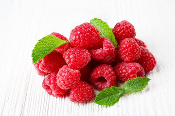 Fresh red raspberries on wooden background