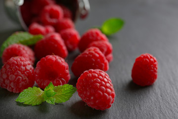 Fresh red raspberries on wooden table, closeup