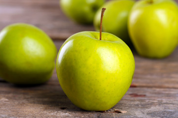 Ripe green apples on wooden table close up