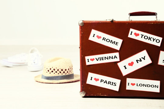 Suitcase with stickers on floor in room