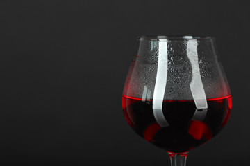 Glass of red wine on dark background