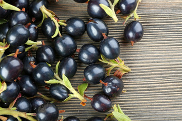 Pile of black currants on wooden table, closeup