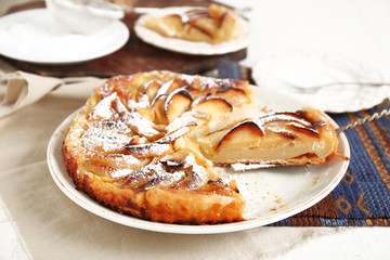 Homemade apple pie on plate, on white wooden table background background
