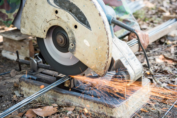 worker cutting steel rod