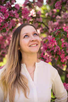 Beauty russian girl under lilac flowers in summer