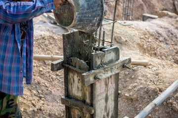 construction worker controlling pile form filling with continuou
