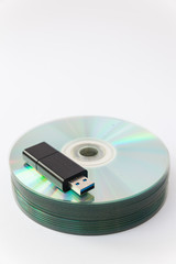 Usb flash drives on stacked CDs isolate on white background.