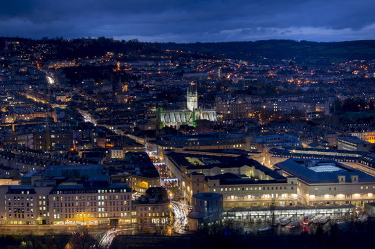 An aerial view of central Bath shows the Abbey and Southgate development at dusk, Bath, Avon