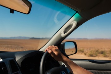 view of a man driving through the desert