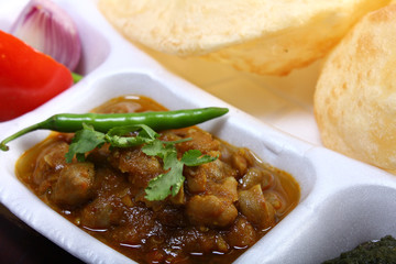indian spicy dish, chole bhature topping of green chili