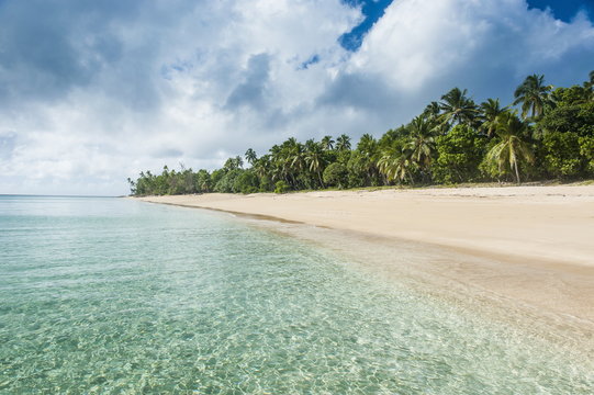 Palm fringed white sand beach in Haapai, Haapai Islands, Tonga, South Pacific