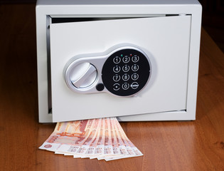 Safe with roubles on wooden shelf