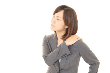 Obraz premium 肩こりに悩む女性
