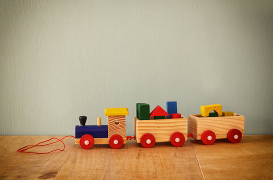 Wooden toy train over wooden table
