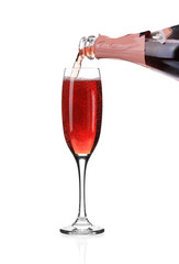 Red champagne pouring in a glass. 